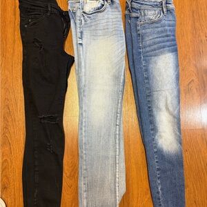 3 pairs of KanCan Stylish Women's Jeans - Black, Light Blue, and Blue